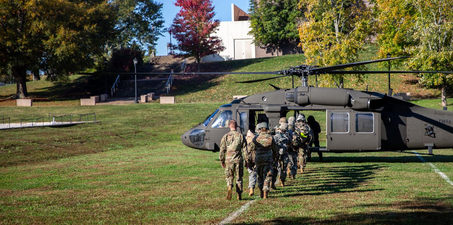 Military Students lined up to get on a helicopter for a training exercise